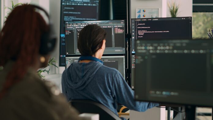Specialist at a computer reviewing online casino software during a brand's first months